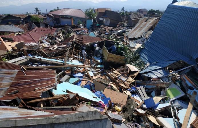 People search through debris in a residential area following an earthquake and tsunami in Palu Indonesia Tsunami