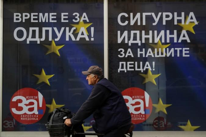 DATE IMPORTED:29 September, 2018A man passes next to posters reading macedonia