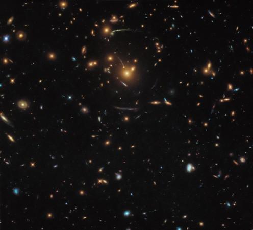 This NASA/ESA Hubble Space Telescope image contains a veritable mix of different galaxies, some of which belong to the same larger structure: At the middle of the frame sits the galaxy cluster SDSS J1050 0017 (Representational image) Gravitational lensing