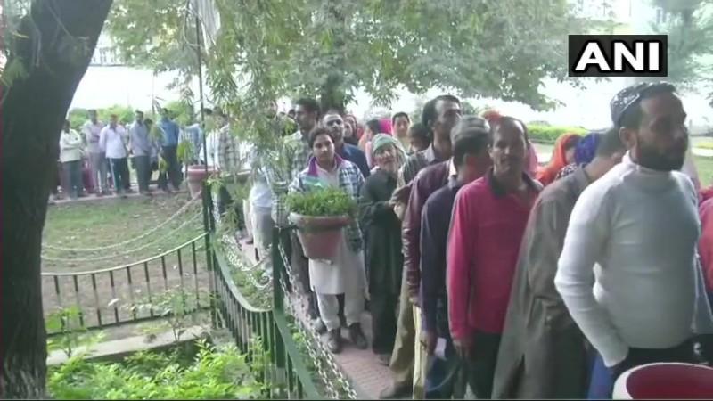 People queue outside a polling booth in Rajouri to cast their votes Jammu and kashmir election