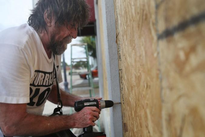 Al Smith puts plywood over a window as he prepares a building for the arrival of hurricane Michael on October 9, 2018 in Port St. Joe Hurricane Michael