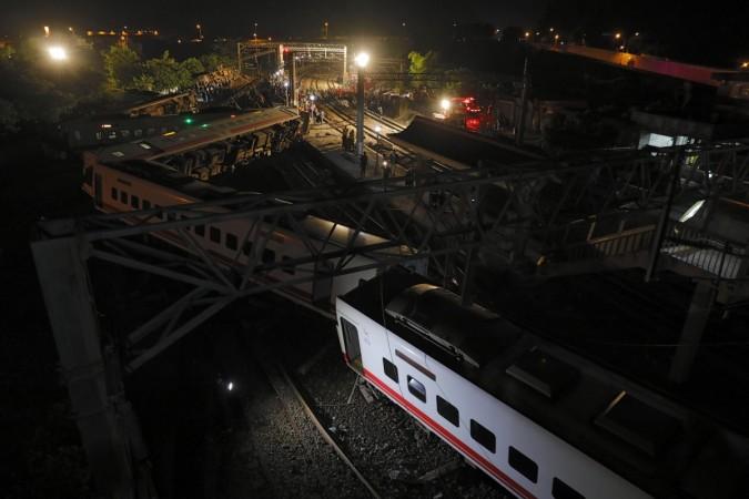 Fire fighters and emergency personnel carry on rescue operations after the Puyuma Express train derailed at high speed near Xima station in Taiwan's northeastern Yilan county Taiwan train accident