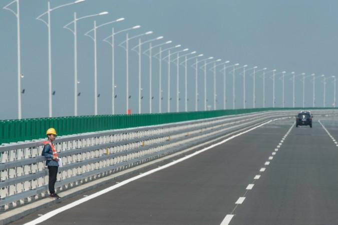 A construction worker stands on a section of the Hong Kong-Zhuhai-Macau Bridge in Zhuhai Hong Kong-Zhuhai bridge