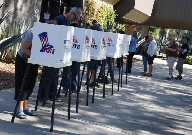 People vote at outdoor booths during early voting for the mid-term elections in Pasadena, California on November 3, 2018. US mid term election