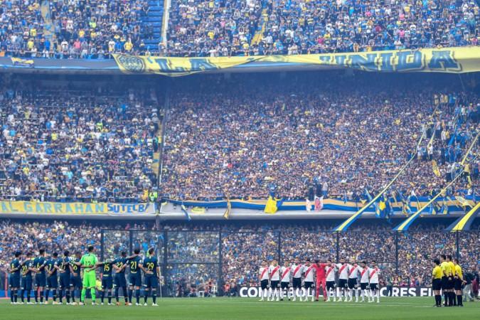 Players of Boca Juniors and River Plate stand during a minute of silence before the first leg match Boca Juniors vs River Plate