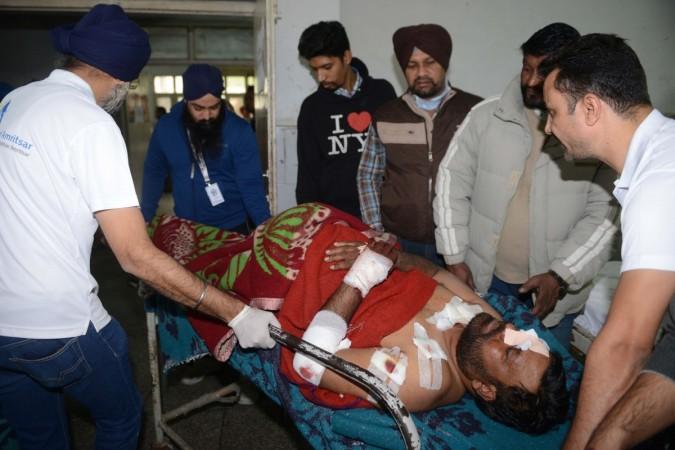 Kuldeep, an injured Indian patient, is shifted to a ward by medical staff following a grenade attack, at the Guru Nanak Dev Hospital in Amritsar on November 18, 2018. - Three people were killed in a grenade attack on a prayer congregation in India's Punjab on November 18 which left some 20 others injured, police said. Amritsar grenade attack in Nirankari Bhavan