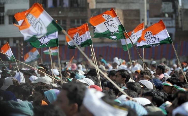 Supporters wave Congress Party flags Supporters wave Congress Party flags
