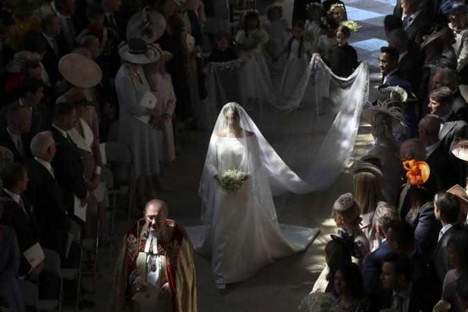 Meghan Markle walks down the aisle in St George's Chapel, Windsor Castle, in Windsor, on May 19, 2018 during her wedding to Britain's Prince Harry, Duke of Sussex Meghan Markle wedding dress