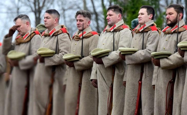 Members of military history clubs wearing WWI Russian military uniforms attend a ceremony marking the centenary of the Armistice Day at the Brotherly cemetery of WWI heroes in Tsarskoye Selo outside Saint Petersburg on November, 11, 2018.