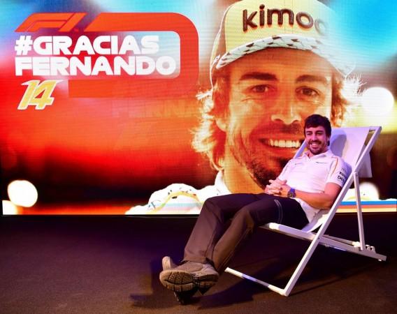 Fernando Alonso poses for photographers during his farewell party at the Yas Marina circuit on November 24, 2018 Fernando Alonso