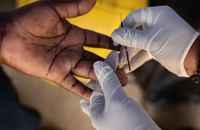A finger prick is used for a rapid HIV test, which provides results in 15 minutes Apple, RED, Global Fund, AIDS, HIV, Worlds AIDS Day, 2018