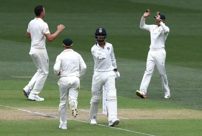Rahul walks off after getting dismissed for 44 as the Aussies celebrate KL Rahul