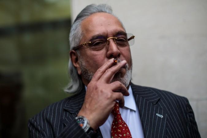 Indian businessman Vijay Mallya smokes during a break in his extradition ruling at Westminster Magistrates Court on December 10, 2018 in London, England. vijay mallya