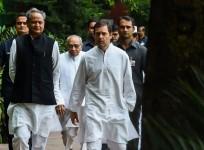 President of the Indian National Congress Party Rahul Gandhi (R) talks with Congress party's national general secretary Ashok Gehlot (L)