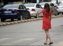 an Indian woman hails a cab at a business district in Mumbai.