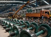 Indian labourers work to build an Indian Railways locomotive coach at Integral Coach Factory in Chennai