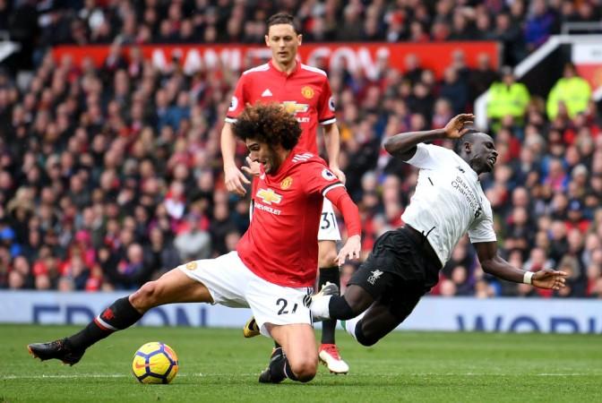 Fellaini taking a piece of the ball and Mane with a sliding tackle Liverpool Manchester United Fellaini Sadio Mane