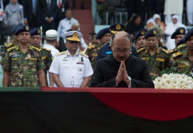 The Indian ambassador to Bangladesh Harsh Vardhan Shringla bows his head after placing a wreath near the casket of a Bangladeshi policeman during a memorial service after armed terrorists stormed an upscale restaurant in a bloody siegein Dhaka on July 4, 2016. Harsh Vardhan Shringla