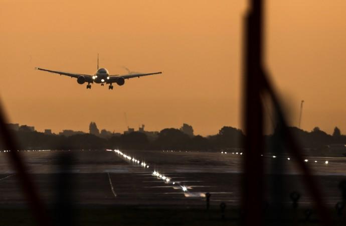 A passenger aircraft prepares to land during sunrise at London Heathrow Airport in west London Heathrow Airport