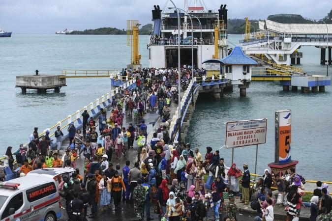 Residents disembark from a ferry at the port after being evacuated from Sebesi Island, in Bakauheni in Lampung province on December 26, 2018, after the December 22 tsunami - caused by activity at a volcano known as the 'child' of Krakatoa - hit the west coast of Indonesia's Java island. - Indonesian search and rescue teams on December 26 plucked stranded residents from remote islands and pushed into isolated communities desperate for aid in the aftermath of a volcano-triggered tsunami that killed over 400. (Photo by MOHD RASFAN / AFP) INDONESIA-DISASTER-TSUNAMI-VOLCANO