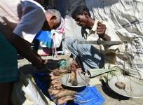 An Indian Tea-tribe vendor sells cooked rats at a weekly market in Kumarikata village along the Indo-Bhutan border