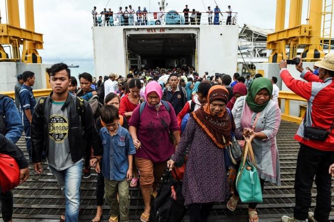 Residents disembark from a ferry at the port after being evacuated from Sebesi Island, in Bakauheni Indonesia Tsunami