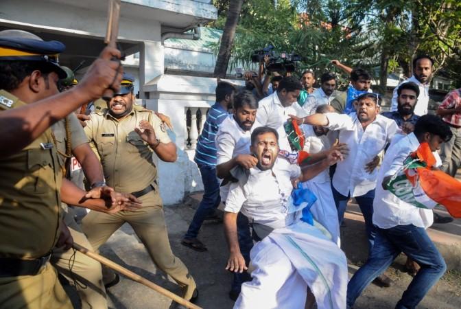 Clashes broke out in southern India for a second day on January 3 as Hindu hardliners went on the rampage, seeking to enforce a general shutdown in protest at two women entering one of the country's holiest temples. Indian police beat Congress Party supporters as they take them into custody during a protest march