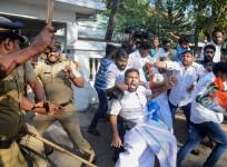 Indian police beat Congress Party supporters as they take them into custody during a protest march