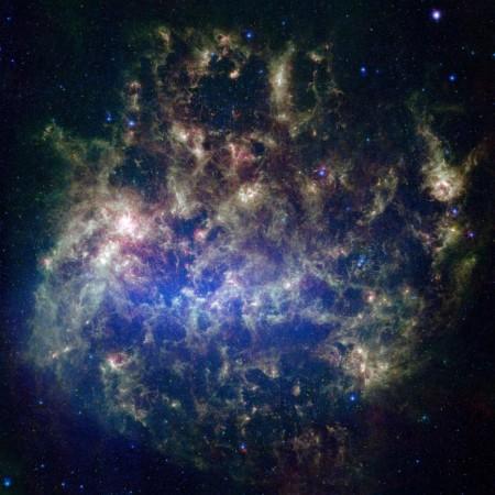 This vibrant image from NASA's Spitzer Space Telescope shows the Large Magellanic Cloud, a satellite galaxy to our own Milky Way galaxy. LMC