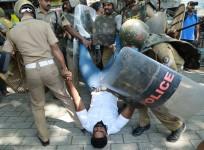 Police detain an Indian activist amid demonstrations after women entered the Sabarimala temple
