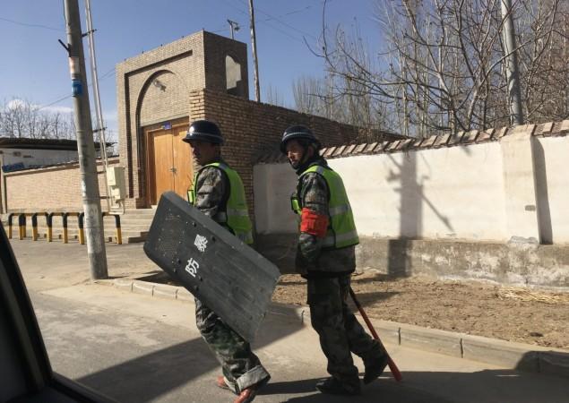 Local police patroling a village in Hotan prefecture, in China's western Xinjiang region China's western Xinjiang region