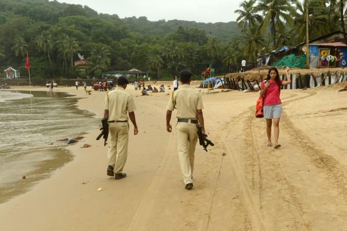 In this photograph taken on September 25, 2016, armed Indian policemen patrol on Baga Beach in Goa. Goa has long attracted Western holidaymakers for its relaxed vibe, but rapid construction, swelling crowds and fears over safety are threatening the Indian state's global reputation as a tranquil haven. / AFP / INDRANIL MUKHERJEE / TO GO WITH AFP STORY: India-Goa-tourism, FEATURE by Peter Hutchison goa police