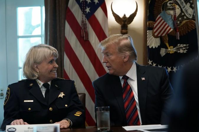 WASHINGTON, DC - JANUARY 11: U.S. President Donald Trump (R) speaks as Sheriff Carolyn 'Bunny' Welsh (L) of Chester County of Pennsylvania listens during a round-table discussion on border security and safe communities with State, local, and community leaders in the Cabinet Room of the White House on January 11, 2019 in Washington, DC. As the second-longest government shut down continues, Democrats and Republicans have not found a compromise for border security funding and President Donald Trump's proposed wall on the U.S.-Mexico border. President Trump Hosts Roundtable On Border Security In Cabinet Room Of White House