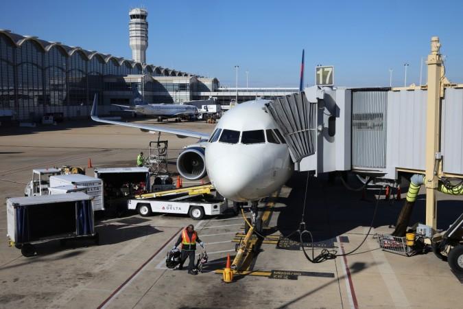 WASHINGTON, DC - NOVEMBER 21: A baggage handler unloads a Delta Airlines plane at Ronald Reagan National Airport on the day before the Thanksgiving holiday November 21, 2018 in Washington, DC. Holiday travel around the Thanksgiving holiday week is expected to be heavier than recent years. Holiday Travel Day Before Thanksgiving Predicted To Be Heavier Than Years Past