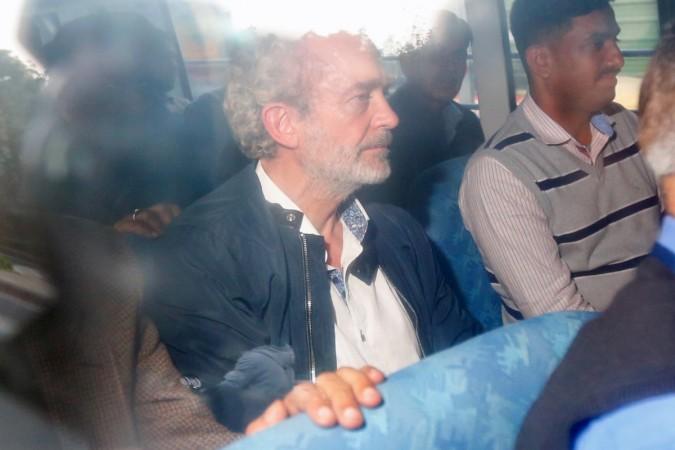 Christian Michel James (C), the alleged middleman in a deal between India and Anglo-Italian helicopter firm AgustaWestland, is pictured in a vehicle while leaving a district court in New Delhi Christian Michel