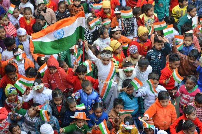 An Indian school girl dressed as Bharat Mata (C) along with children waves a national flag ahead of the 70th Republic Day at a school function in Amritsar on January 25, 2019. - India will celebrate its 70th Republic Day on January 26. republic day