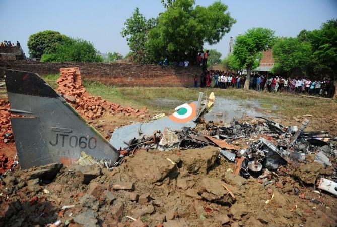 Indian security personnel and villagers gather near the debris of an Indian Air Force (IAF) Jaguar aircraft after it crashed in the Naini area of Allahabad on June 16, 2015 according to local reports both aircrew are safe and there are no casualties. INDIA-AVIATION-CRASH