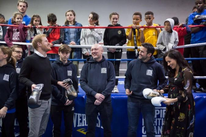 Prince Harry, Duke of Sussex and Meghan, Duchess of Sussex are presented with boxing gloves during their visit to the Boxing Charity, Empire Fighting Chance on February 1, 2019 in Bristol, England. Prince Harry
