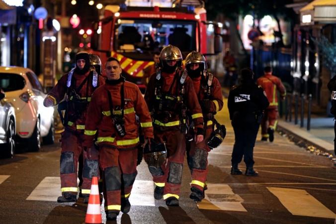 Firefighters are seen near a building that caught fire in the 16th arrondissement in Paris, on February 5, 2019. - Seven people died and another was seriously injured in a building fire in a wealthy Paris neighbourhood on Monday night, the fire service said. The blaze in the French capital's trendy 16th arrondissement also left 27 people -- including three firefighters -- with minor injuries. Paris fire