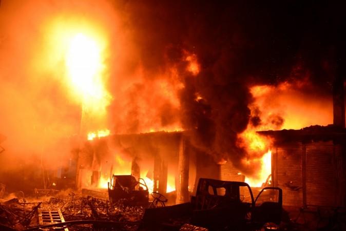 Flames and smoke rise from building after a fire broke out in an old part of the Bangladeshi capital Dhaka on February 21, 2019. - At least 69 people have died in a huge blaze that tore through apartment buildings also used as chemical warehouses in an old part of the Bangladeshi capital Dhaka, fire officials said on February 21. dhaka fire