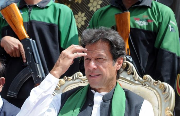 Chairman of Pakistan Tehreek-e-Insaaf (PTI) or Movement for Justice party, Imran Khan is escorted by police commandos as he attends a general election campaign meeting in Murree on April 29, 2013. Chairman of Pakistan Tehreek-e-Insaaf (PTI) or Movement for Justice party, Imran Khan