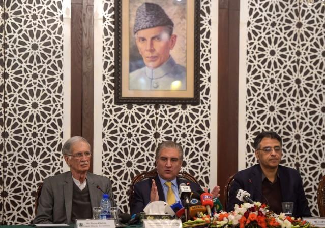 Pakistani Foreign Minister Shah Mehmood Qureshi (C) speaks next to Defence Minister Pervez Khattak (L) and Finance Minister Asad Umar (R) during a press conference at the Foreign Affairs Ministry in Islamabad on February 26, 2019, following the Indian Air Force (IAF) strike launched on a Jaish-e-Mohammad (JeM) camp at Balakot. Pakistan defence minister