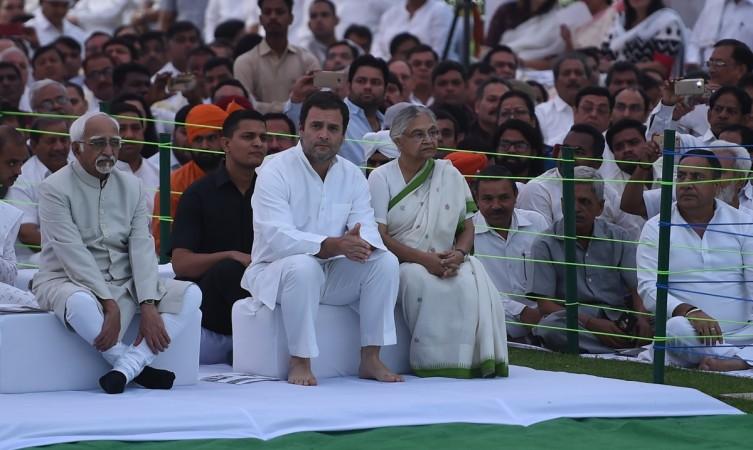 Indian Congress party president Rahul Gandhi (C), accompanied by former New Delhi chief minister Sheila Dikshit