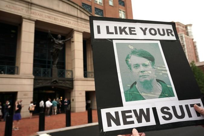 An activist holds a picture of former Trump campaign chairman Paul Manafort during a protest outside the Albert V. Bryan United States Courthouse prior to the first day of the trial of Manafort July 31, 2018 in Alexandria, Virginia. Manafort was charged with financial frauds and is the first defendant in special counsel Robert Mueller's investigation into Russian interference in the 2016 presidential election to face trial. An activist holds a picture of former Trump campaign chairman Paul Manafort