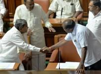H.D Kumaraswamy (R) greets former Chief Minister Siddaramaiah