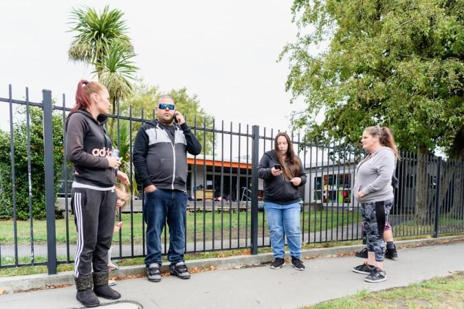 Members of the public refuse to leave without their children as their school, Te Waka Unua School, is in lockdown on March 15, 2019 in Christchurch, New Zealand. New Zealand mosque shooting