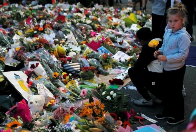 People visit a memorial site for victims of New Zealand shooting, in front of the Masjid Al Noor mosque in Christchurch. New Zealand shooting