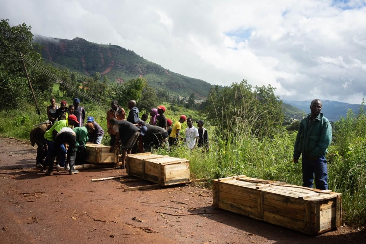 Men carry coffins along a makeshift path on the river in Ngangu township Chimanimani, Manicaland Province, eastern Zimbabwe Cyclone Idai