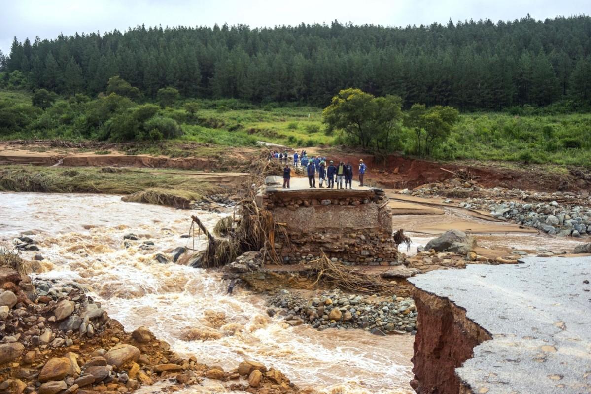 Timber company workers stand stranded on a damaged road on March 18, 2019, at Charter Estate, Chimanimani, eastern Zimbabwe, after the area was hit by the cyclone Idai. Cyclone Idai