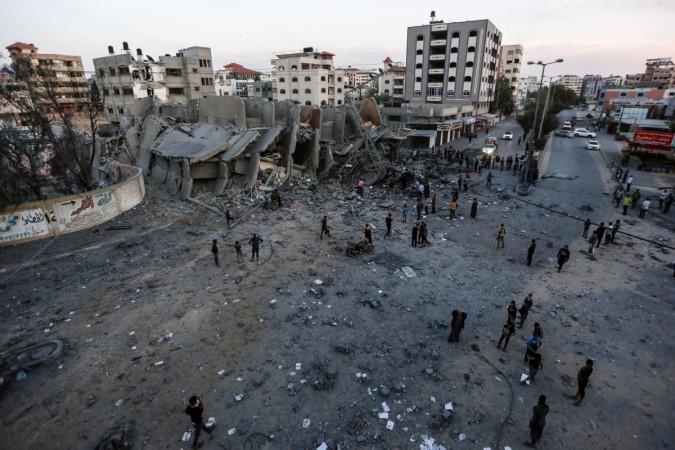 Palestinians inspect the remains of a building that was destroyed during Israeli airstrikes on Gaza City, on May 5, 2019